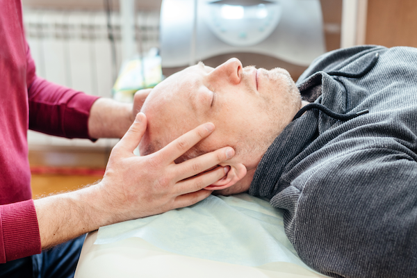 Patient receiving cranial sacral treatment